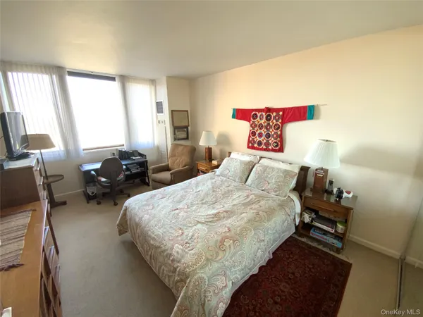 a bedroom with bed and window