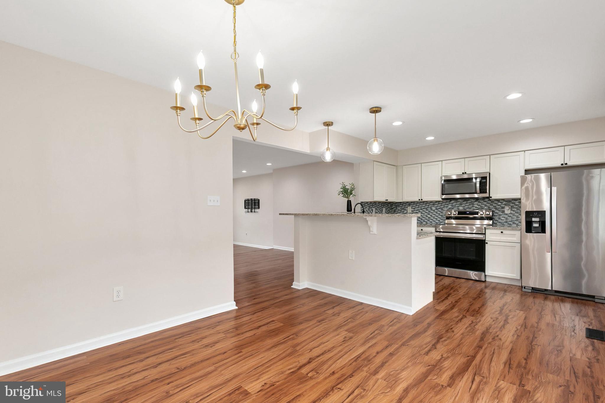 3133 Beaverwood Lane Silver Spring, MD 20906 - Photo 13 of 41 a view of a kitchen with a sink dishwasher a refrigerator and wooden floor