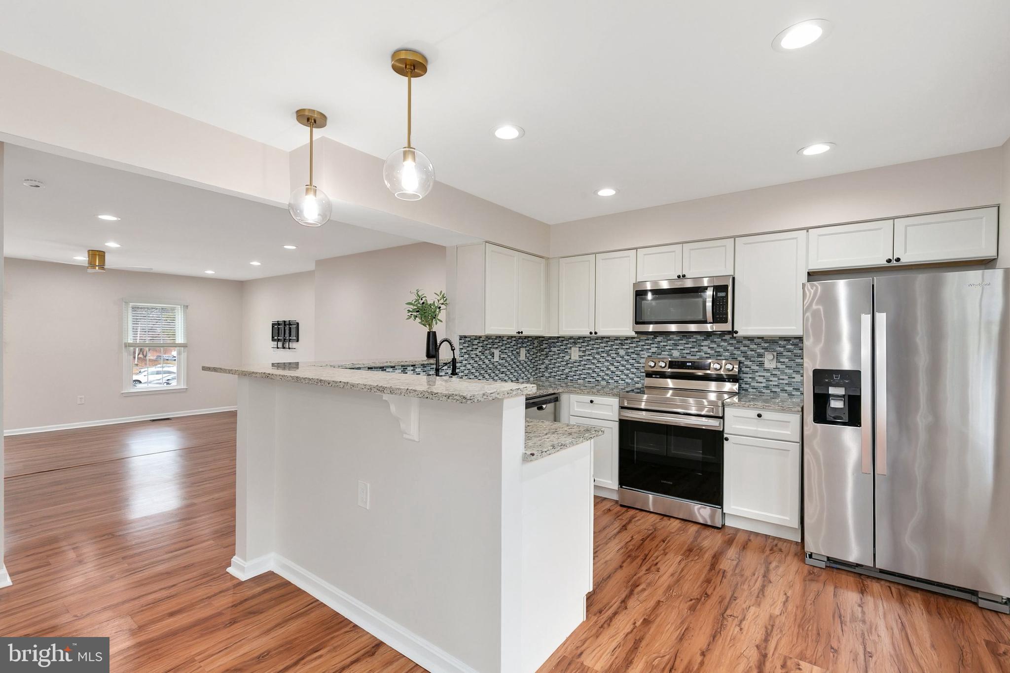 3133 Beaverwood Lane Silver Spring, MD 20906 - Photo 14 of 41 a kitchen with stainless steel appliances a refrigerator sink and stove top oven