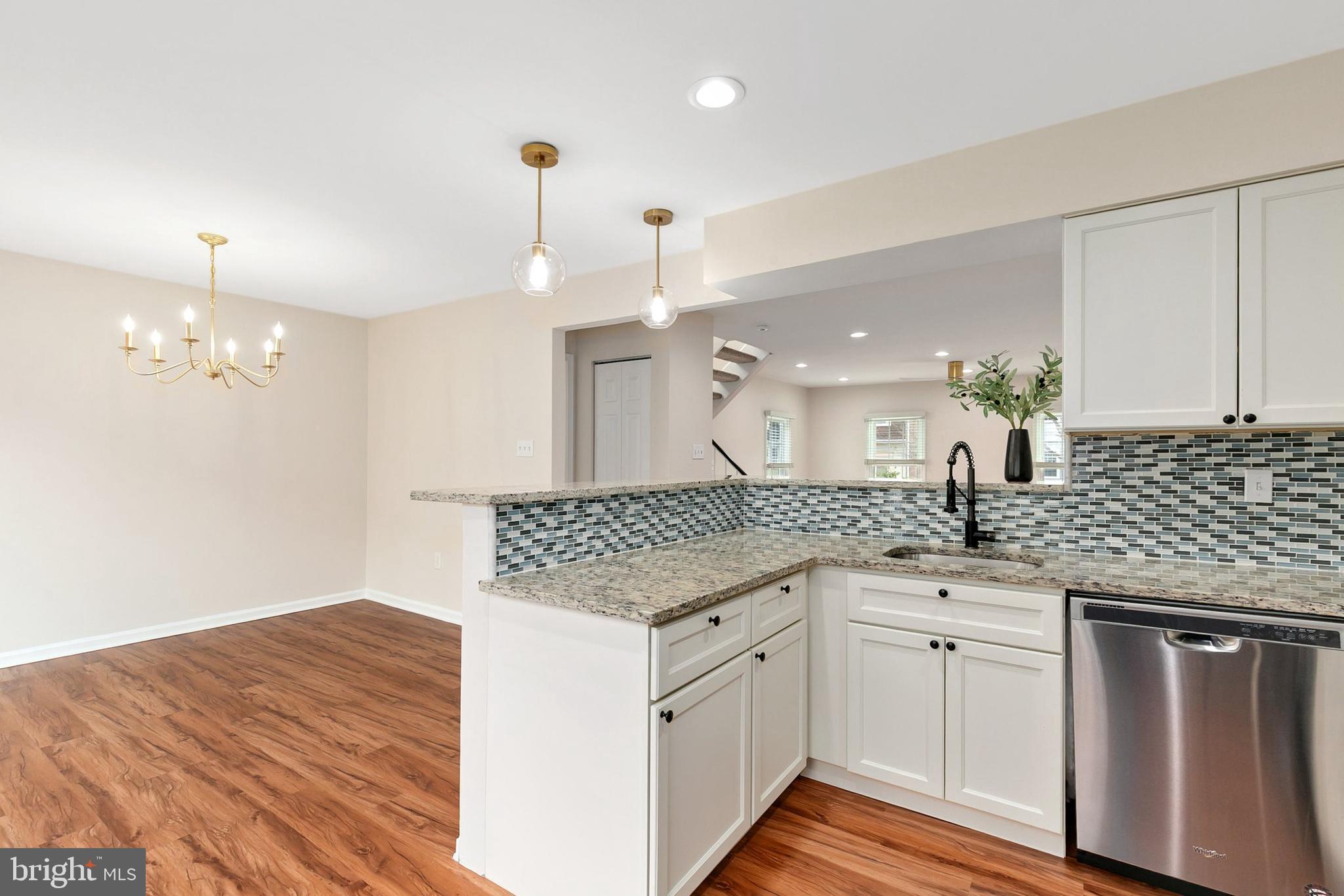 3133 Beaverwood Lane Silver Spring, MD 20906 - Photo 16 of 41 a kitchen with granite countertop a sink cabinets and wooden floor