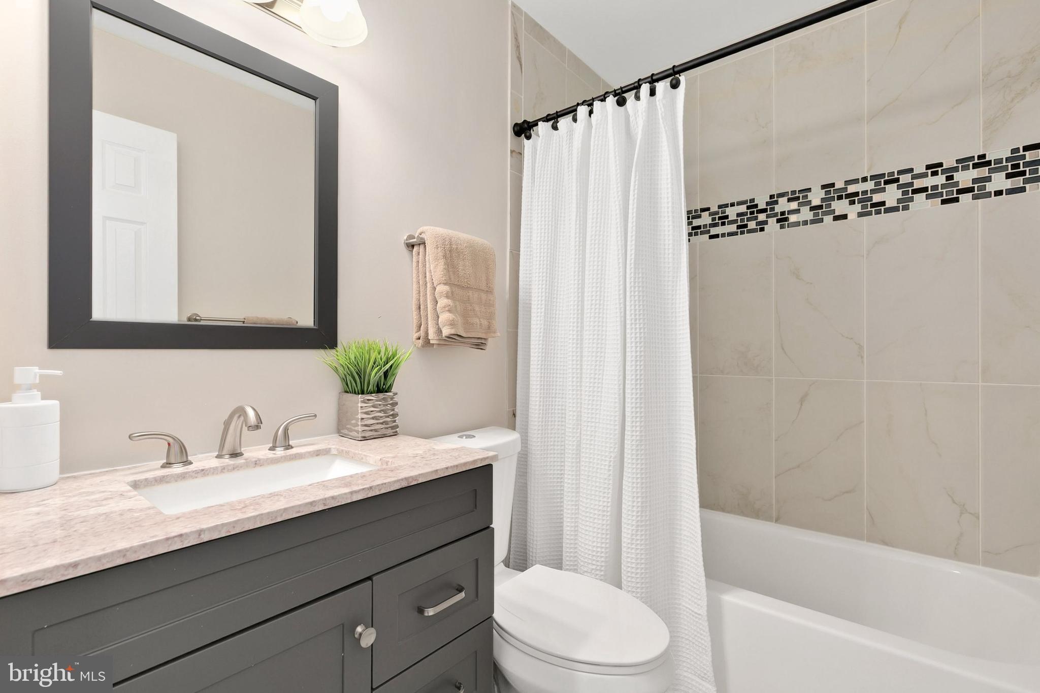 3133 Beaverwood Lane Silver Spring, MD 20906 - Photo 29 of 41 a bathroom with a granite countertop sink toilet and shower