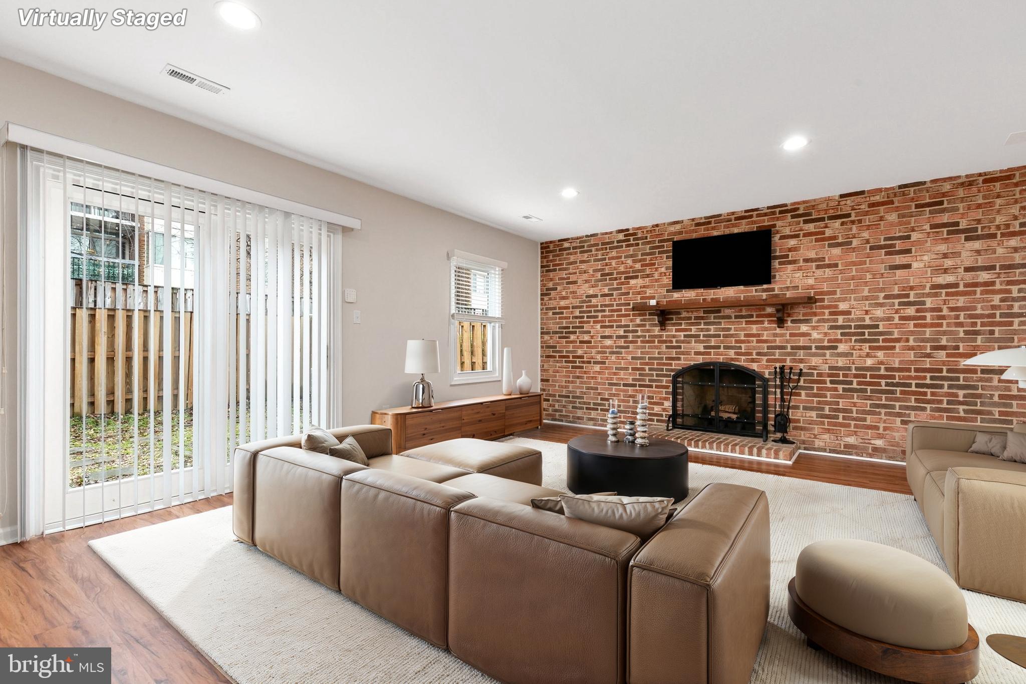 3133 Beaverwood Lane Silver Spring, MD 20906 - Photo 30 of 41 a living room with furniture a fireplace and a flat screen tv