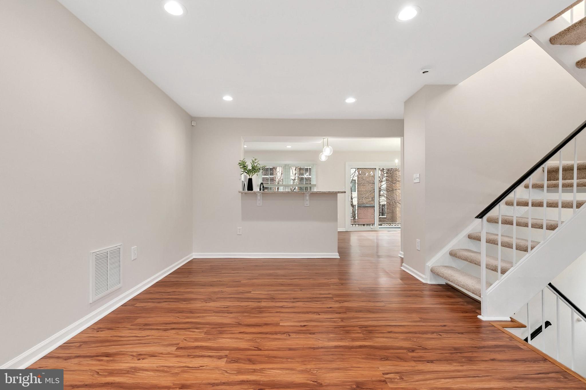 3133 Beaverwood Lane Silver Spring, MD 20906 - Photo 8 of 41 a view of an empty room with wooden floor and stairs