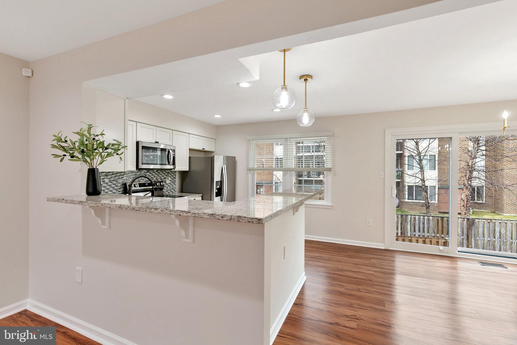 3133 Beaverwood Lane Silver Spring, MD 20906 - Photo 10 of 41 a view of a kitchen with kitchen island a large counter top space and living room