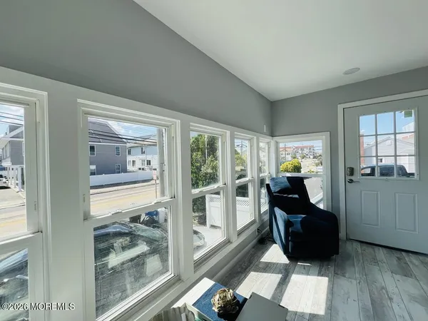 a living room with furniture and a floor to ceiling window