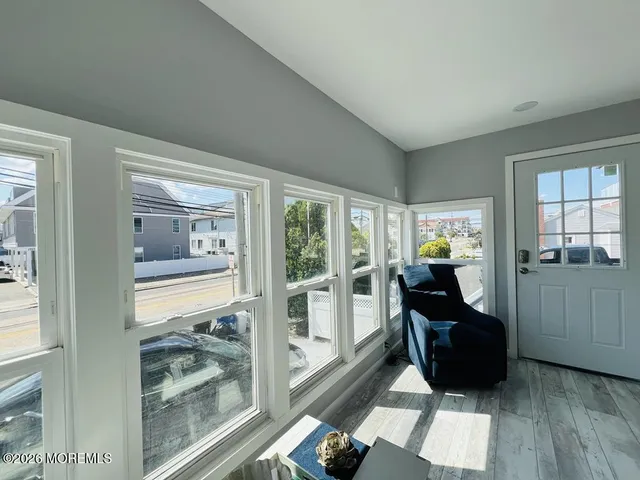 a living room with furniture and a floor to ceiling window