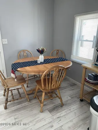 a view of a dining room with furniture and a window