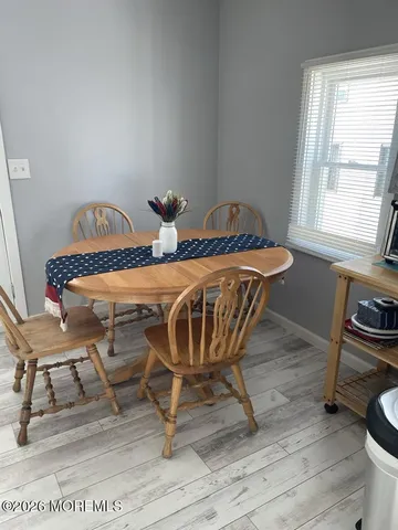 a view of a dining room with furniture and a window