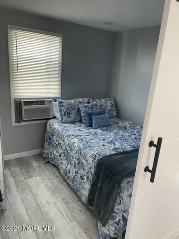 a living room with a bed furniture and a window