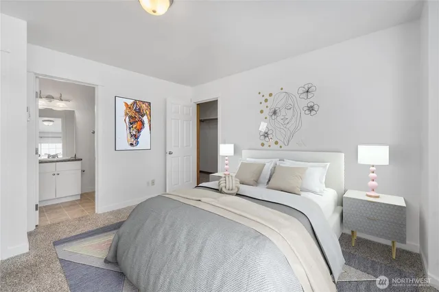 a bedroom with a bed and a painting on the wall