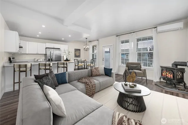 a living room with furniture and a view of kitchen