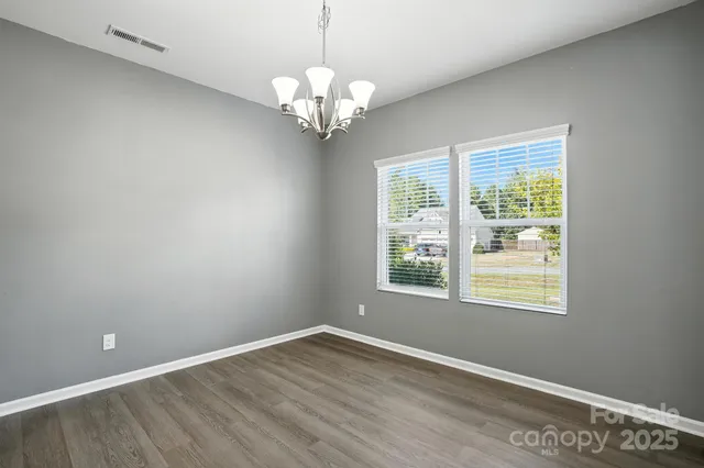 wooden floor in an empty room with a mirror