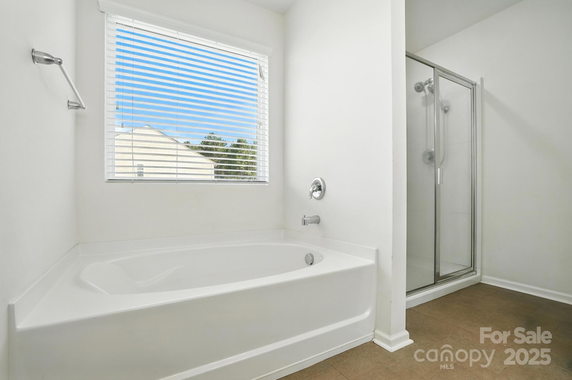 6405 Fawn Crest Drive Waxhaw, NC 28173 - Photo 20 of 38 a white bath tub sitting next to a window