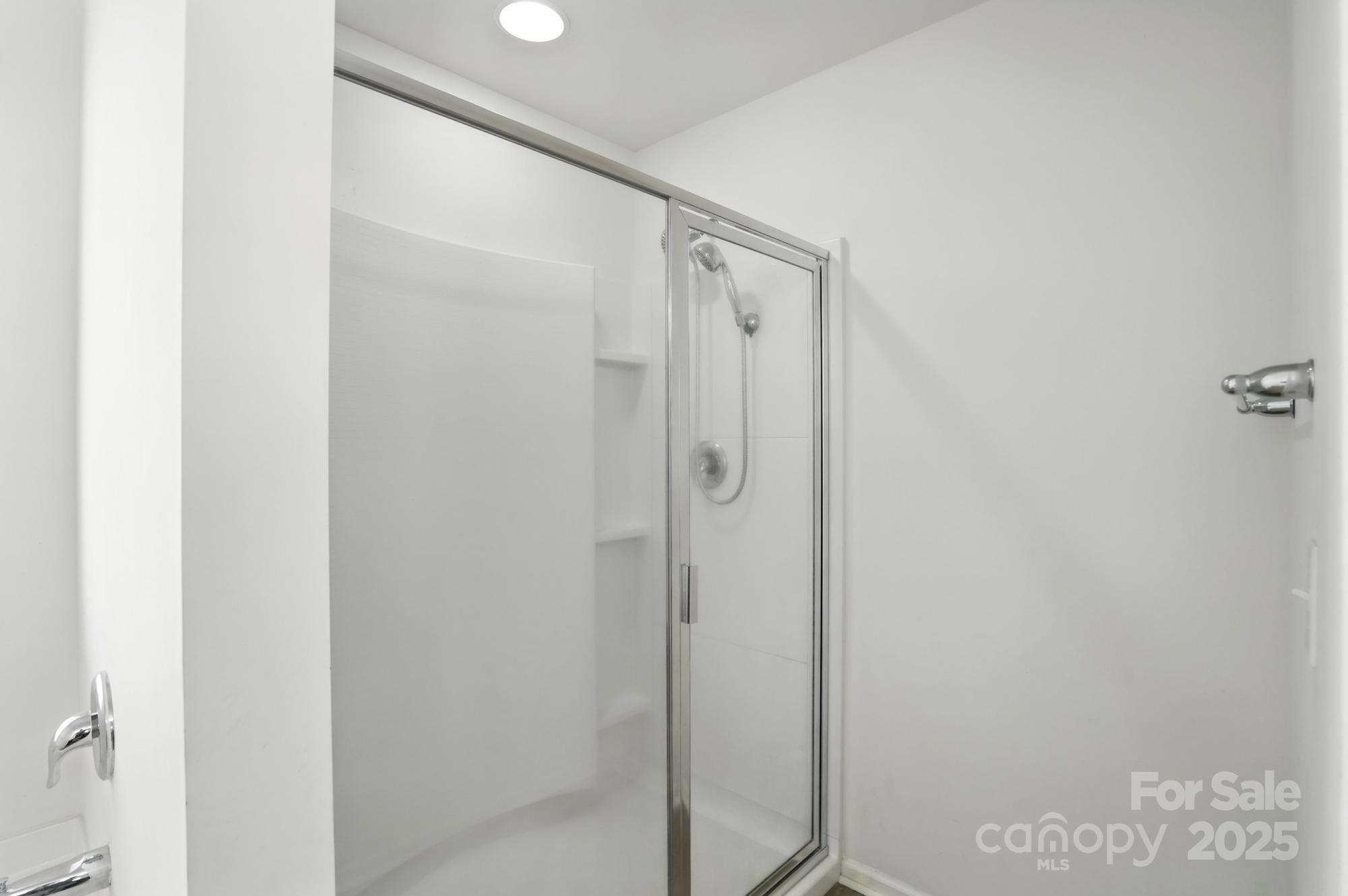 6405 Fawn Crest Drive Waxhaw, NC 28173 - Photo 21 of 38 a bathroom with a glass shower door