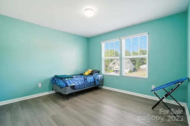 a bedroom with bed and a window