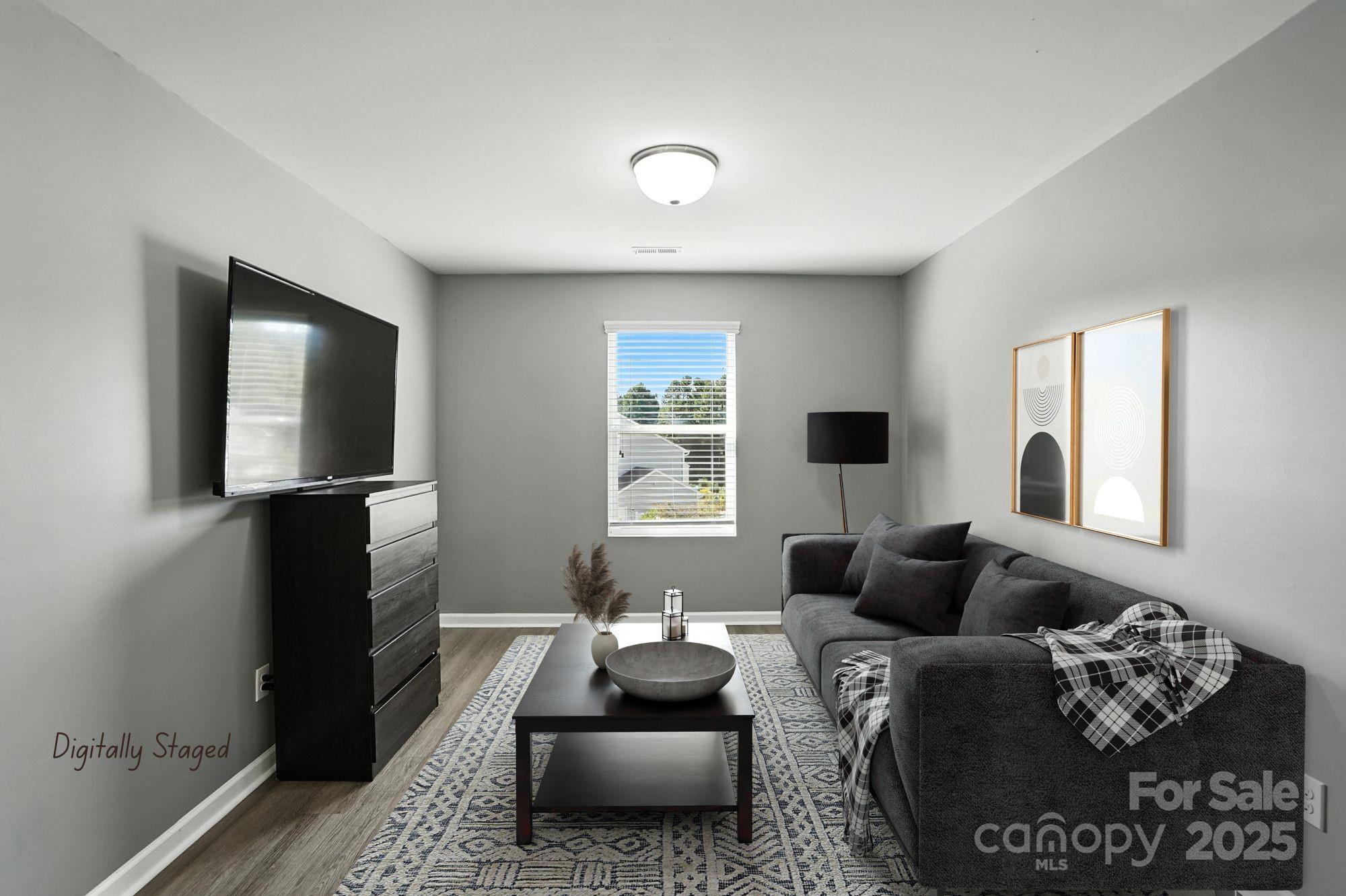 6405 Fawn Crest Drive Waxhaw, NC 28173 - Photo 25 of 38 a living room with furniture and a flat screen tv