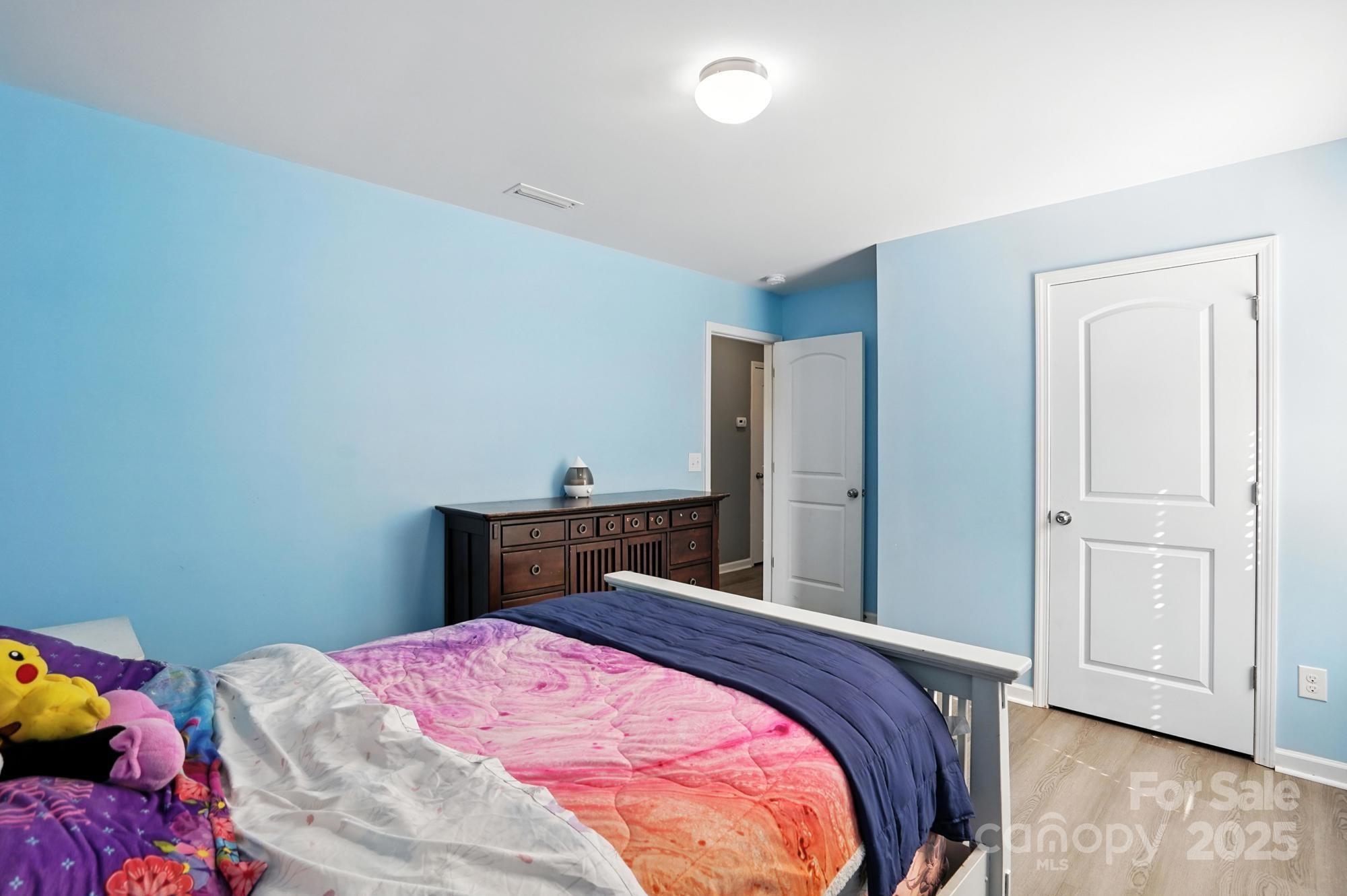 6405 Fawn Crest Drive Waxhaw, NC 28173 - Photo 28 of 38 a bedroom with a bed and wooden floor