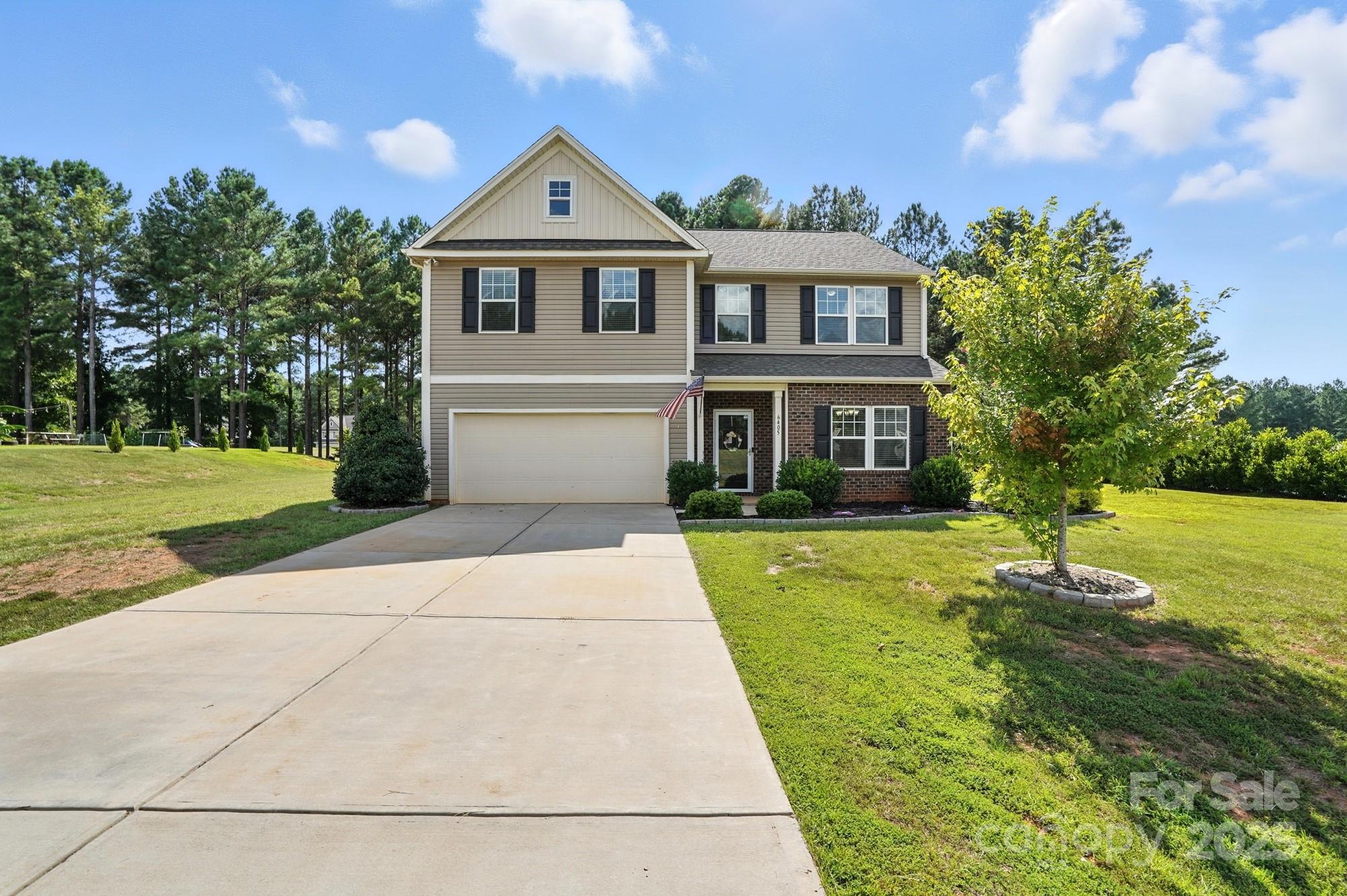 6405 Fawn Crest Drive Waxhaw, NC 28173 - Photo 3 of 38 a front view of a house with garden