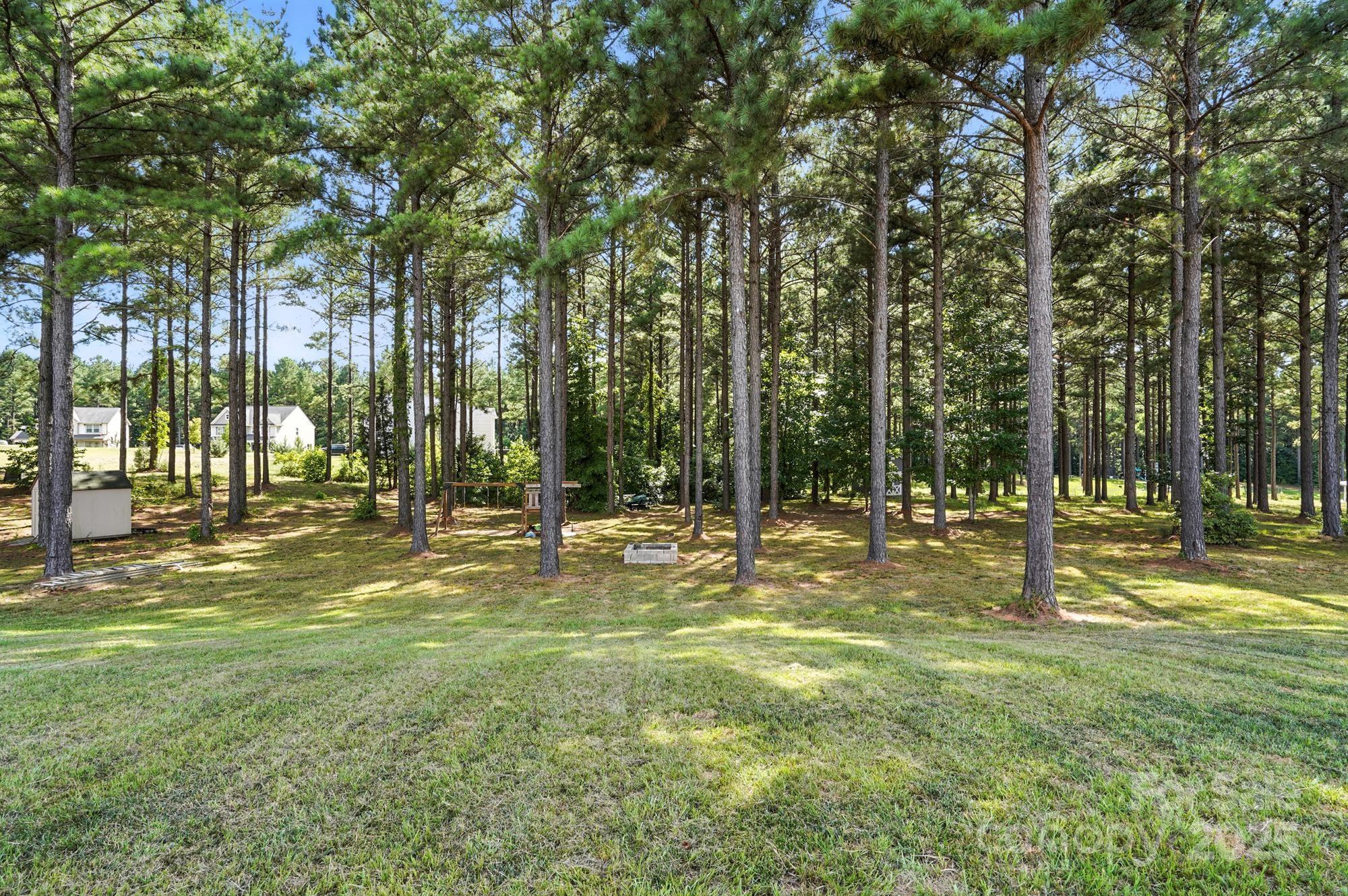 6405 Fawn Crest Drive Waxhaw, NC 28173 - Photo 33 of 38 a swimming pool with trees in the background