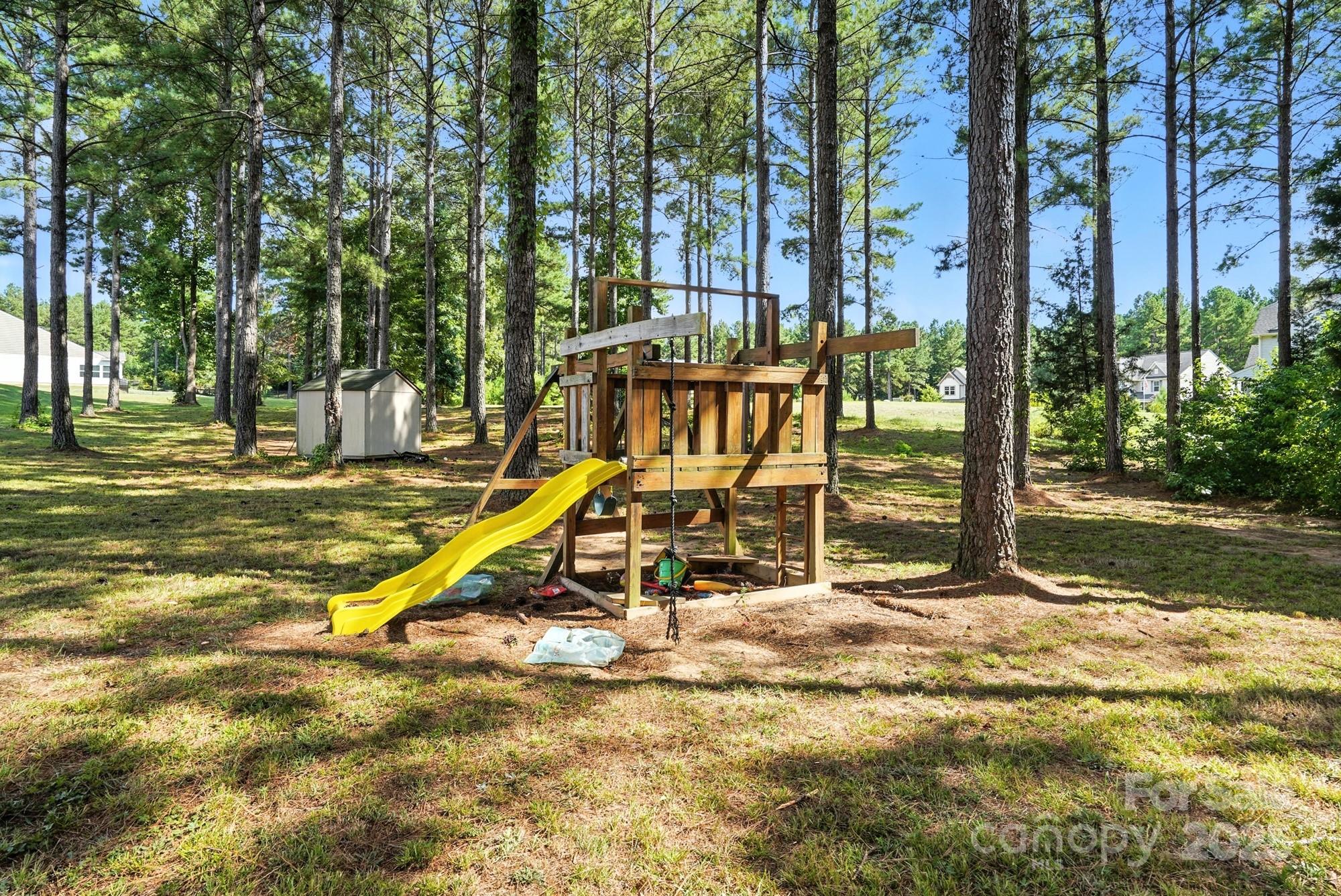 6405 Fawn Crest Drive Waxhaw, NC 28173 - Photo 37 of 38 a view of a park with swings and slides