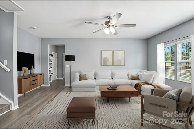 a living room with furniture and a flat screen tv