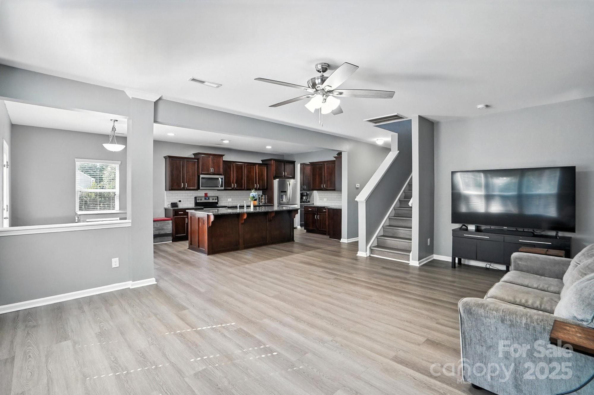 6405 Fawn Crest Drive Waxhaw, NC 28173 - Photo 9 of 38 a living room with furniture and a flat screen tv