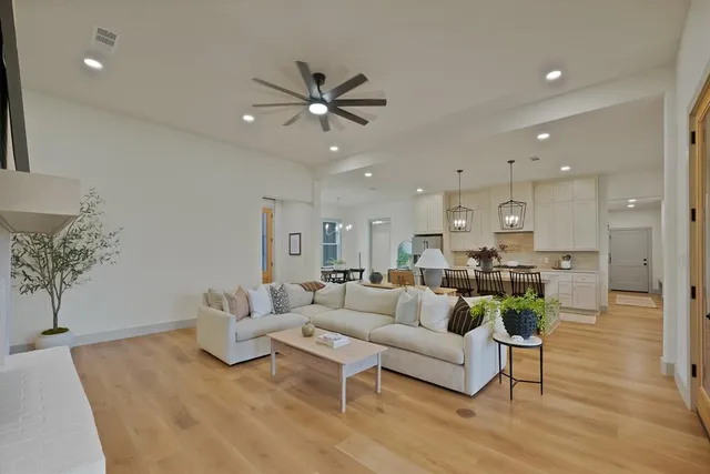 a living room with furniture and kitchen view