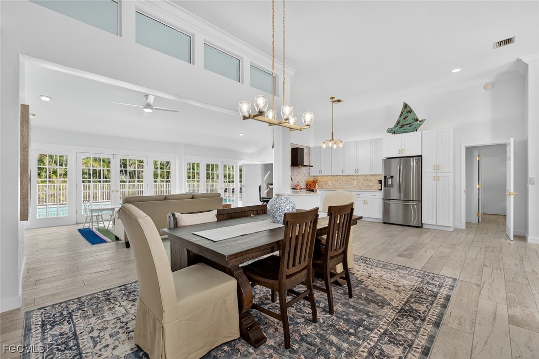 13570 Harbour Ridge Drive Fort Myers, FL 33908 - Photo 11 of 50 a view of a dining room with furniture and a chandelier