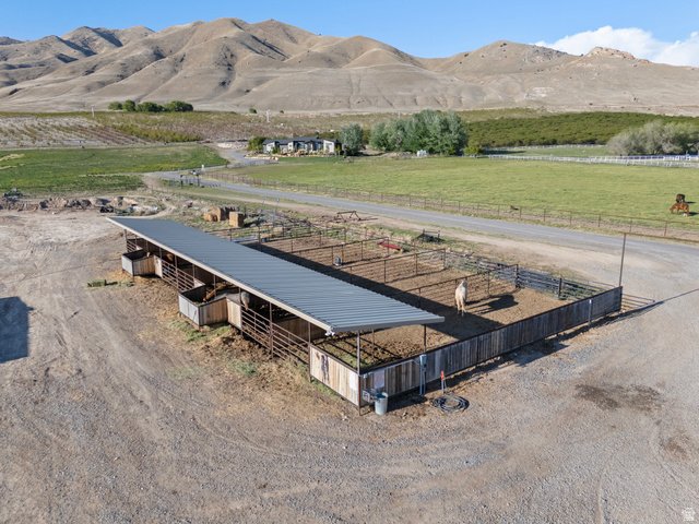 115 East 1600th Street North Santaquin, UT 84655 - Photo 40 of 52 Outdoor animal enclosure featuring a covered shelter with multiple stalls, fenced paddocks, and a spacious gravel yard