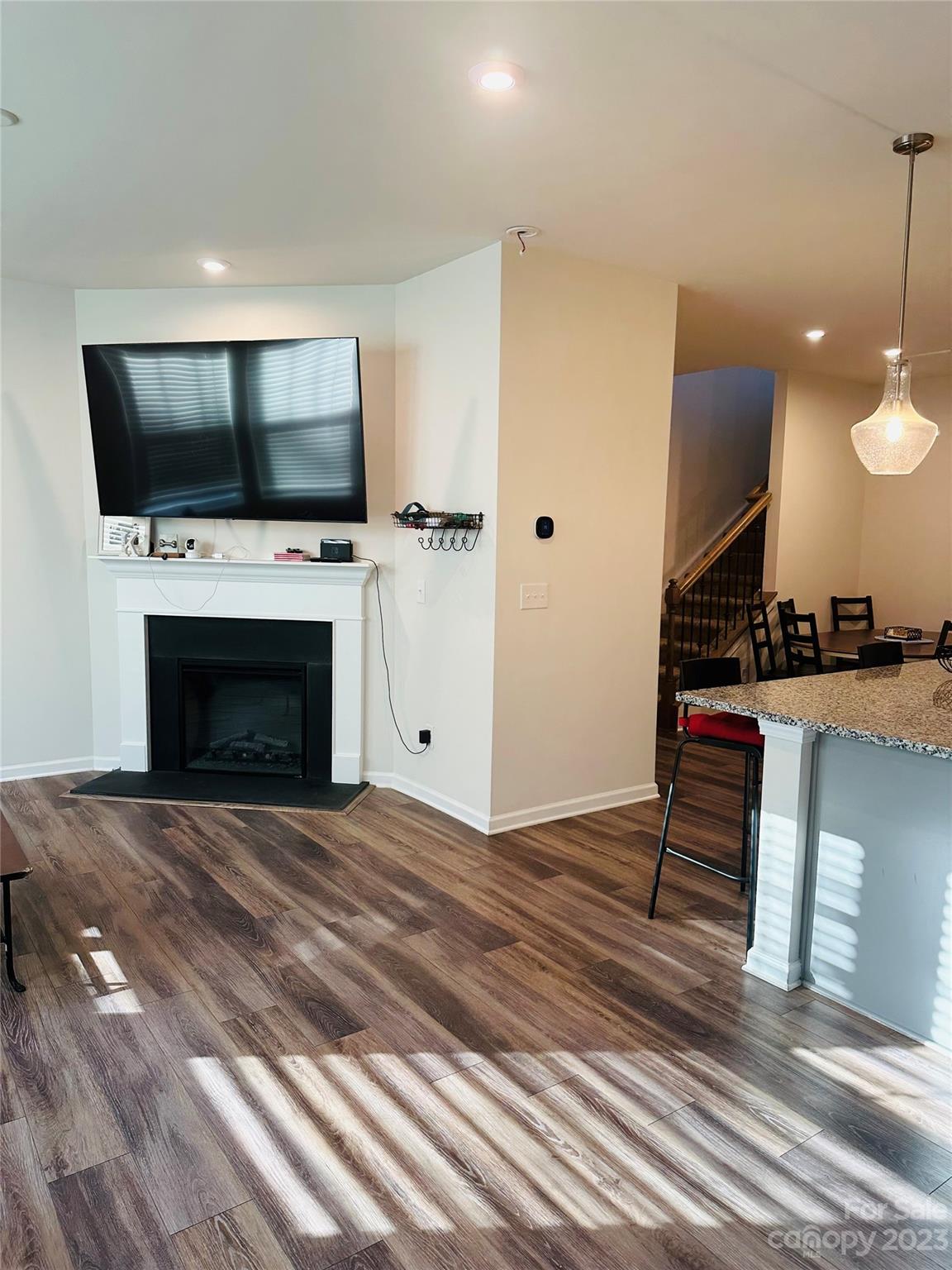 1424 Galloway Road Charlotte, NC 28262 - Photo 2 of 18 a living room with furniture a flat screen tv and a fireplace