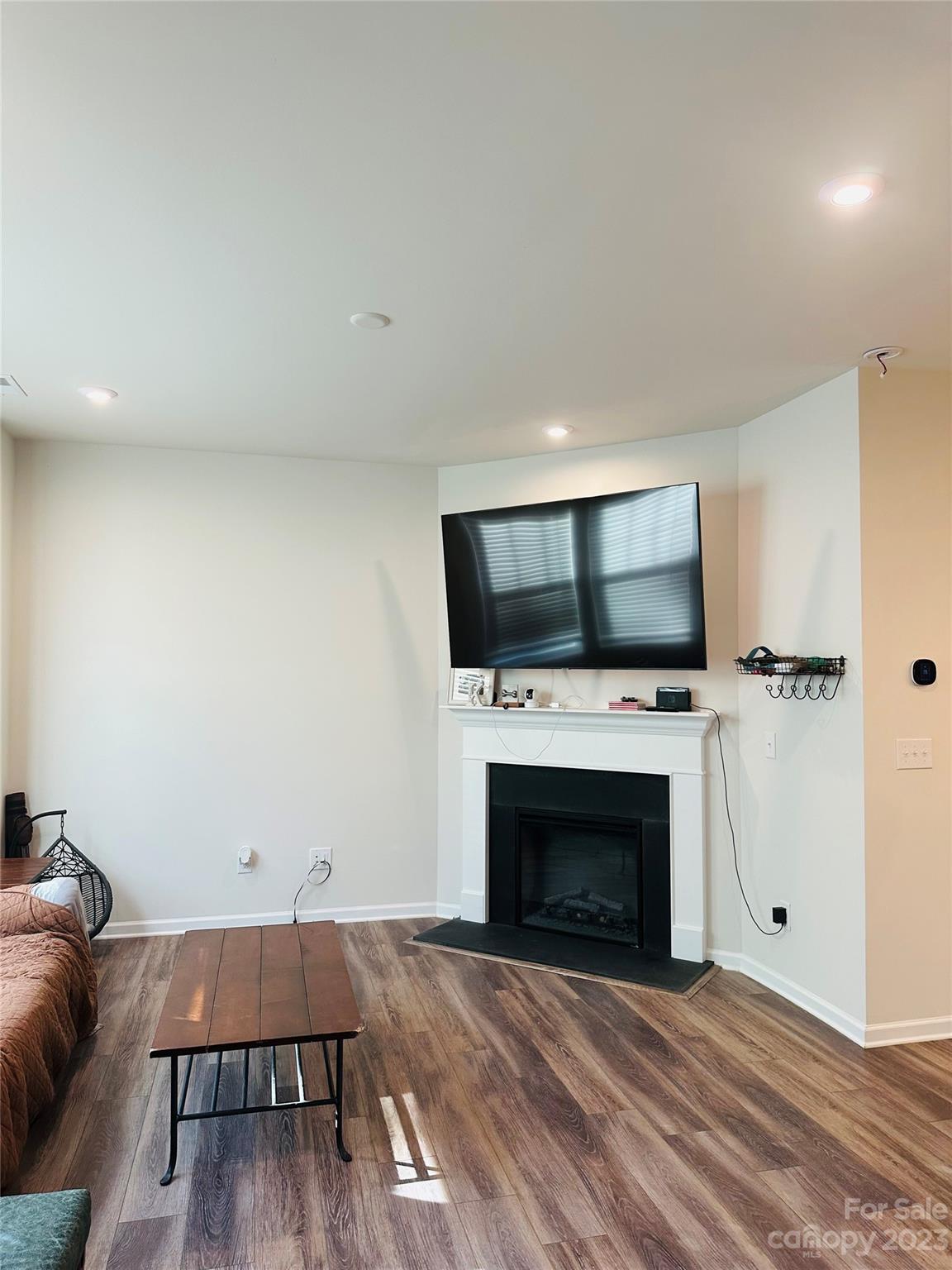 1424 Galloway Road Charlotte, NC 28262 - Photo 3 of 18 a living room with a fireplace and a flat screen tv