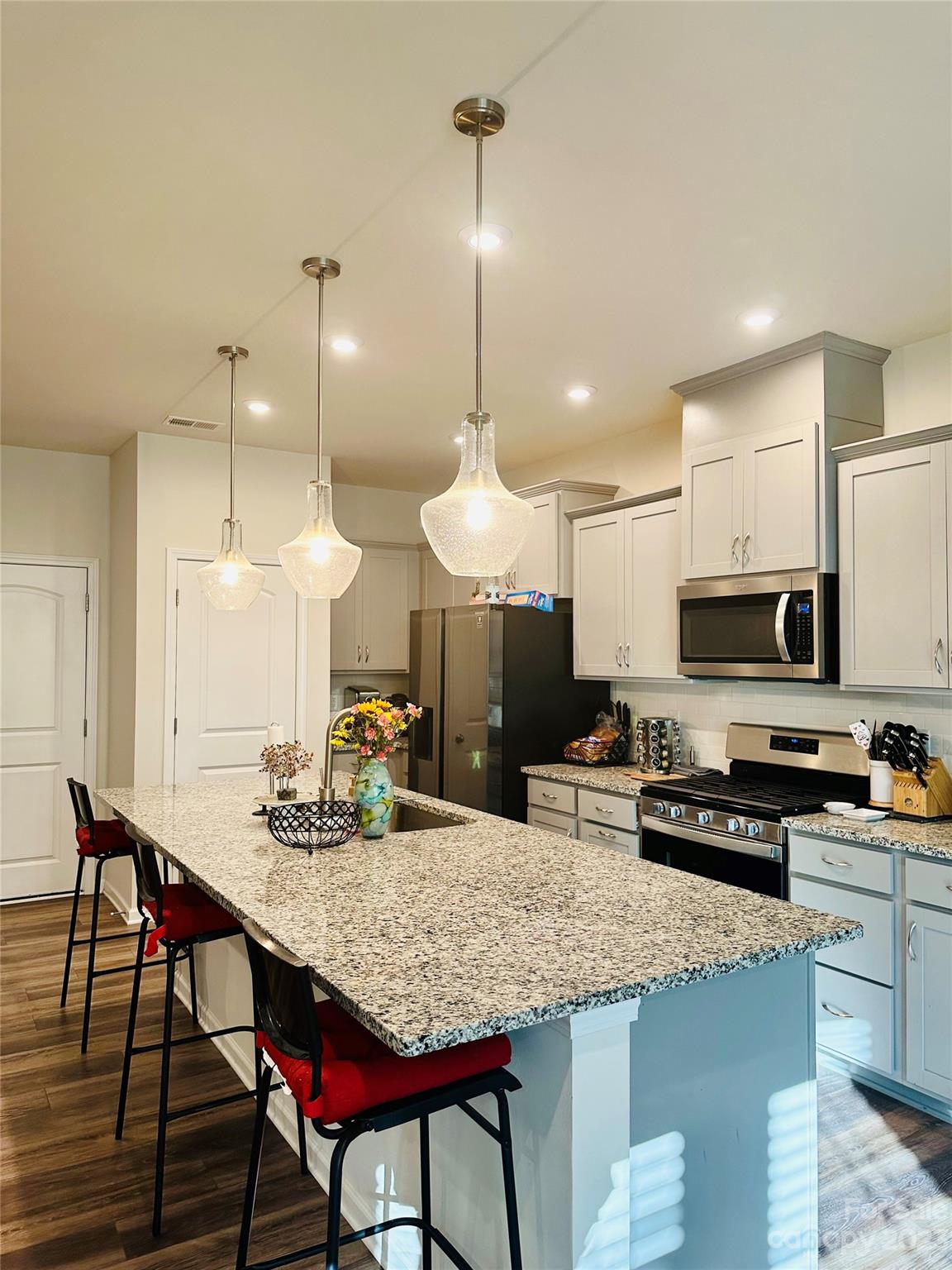 1424 Galloway Road Charlotte, NC 28262 - Photo 4 of 18 a kitchen with a dining table chairs and a refrigerator