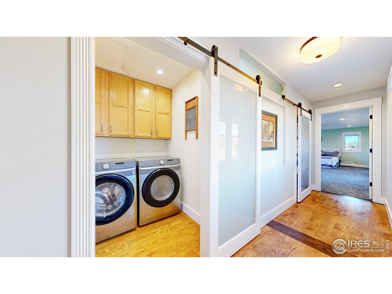 5708 South Timberline Road Fort Collins, CO 80528 - Photo 14 of 49 Hallway utilizes space for laundry room with storage and modern sliding barn door design