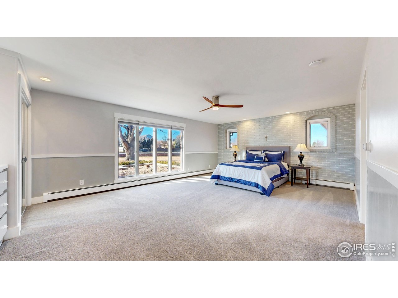 5708 South Timberline Road Fort Collins, CO 80528 - Photo 18 of 49 Second primary suite with large-scale windows ensures abundant natural lighting.