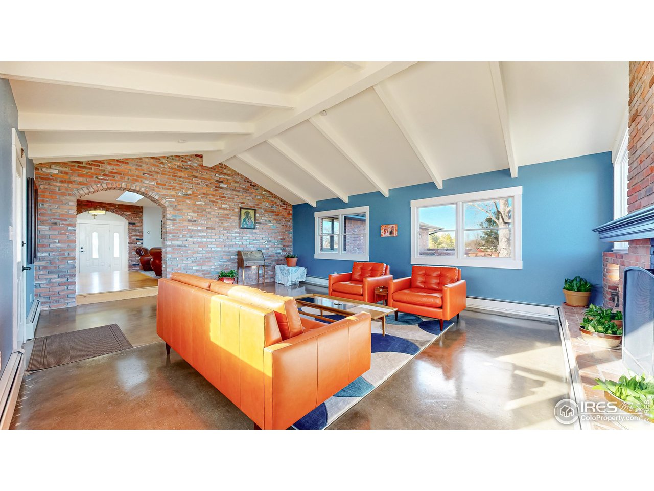 5708 South Timberline Road Fort Collins, CO 80528 - Photo 25 of 49 Masonry, stonework, and vaulted ceilings with exposed beams make this area a unique family room to spend time