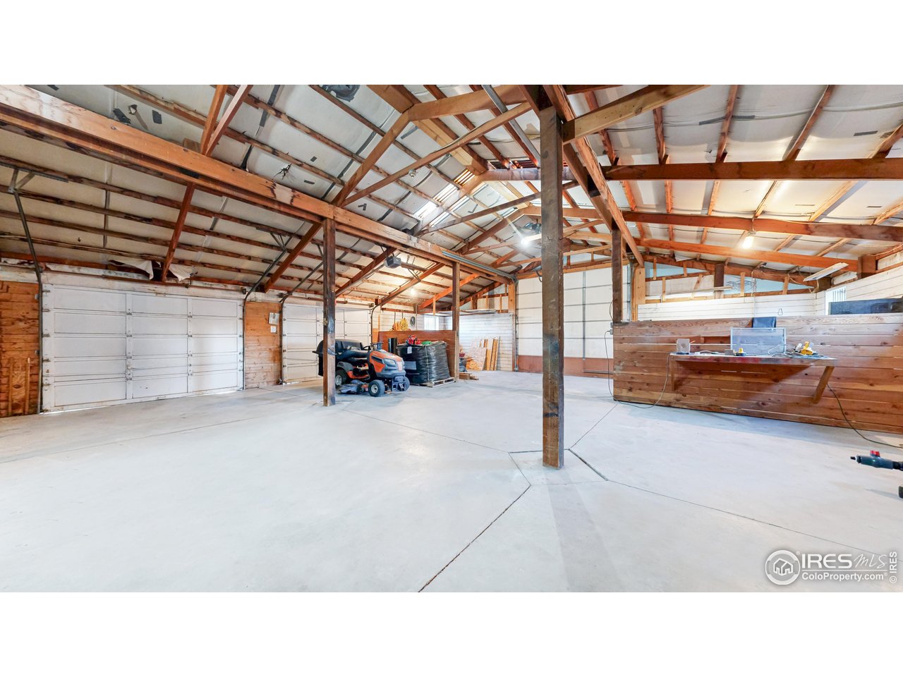 5708 South Timberline Road Fort Collins, CO 80528 - Photo 45 of 49 Pole barn featuring oversized garage doors along with a utility washroom with utility shower area