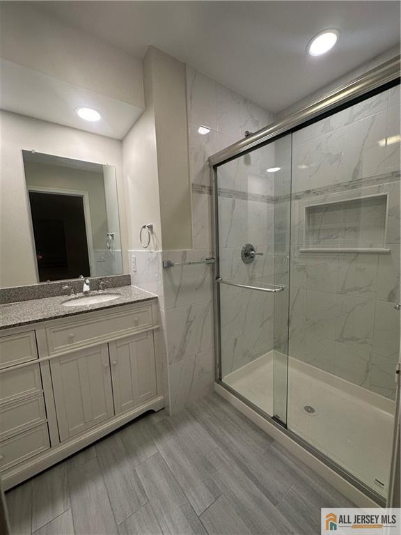 204 Maplecrest Road, Unit 204 Edison, NJ 08820 - Photo 12 of 15 a bathroom with a shower sink and mirror