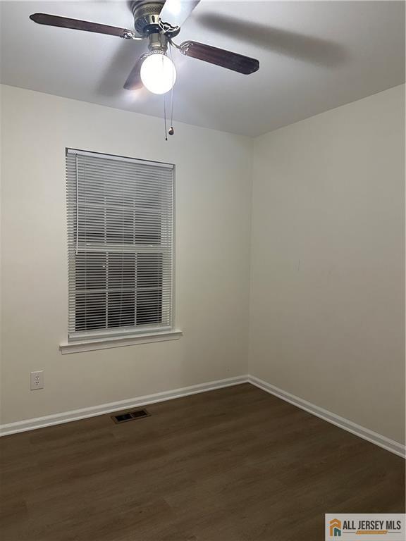 204 Maplecrest Road, Unit 204 Edison, NJ 08820 - Photo 14 of 15 a view of an empty room with wooden floor and a window