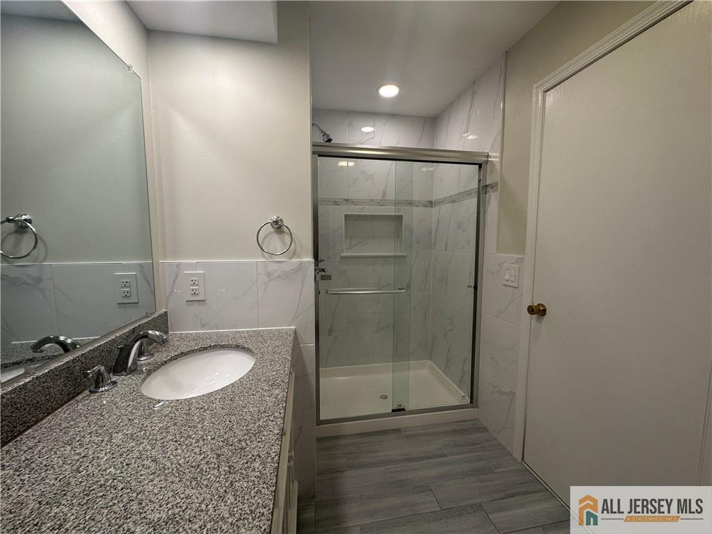 204 Maplecrest Road, Unit 204 Edison, NJ 08820 - Photo 3 of 15 a bathroom with a sink shower and mirror