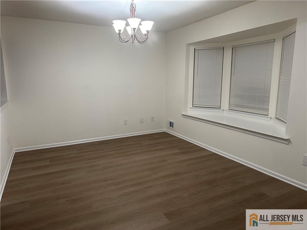 204 Maplecrest Road, Unit 204 Edison, NJ 08820 - Photo 4 of 15 a view of empty room with wooden floor and window