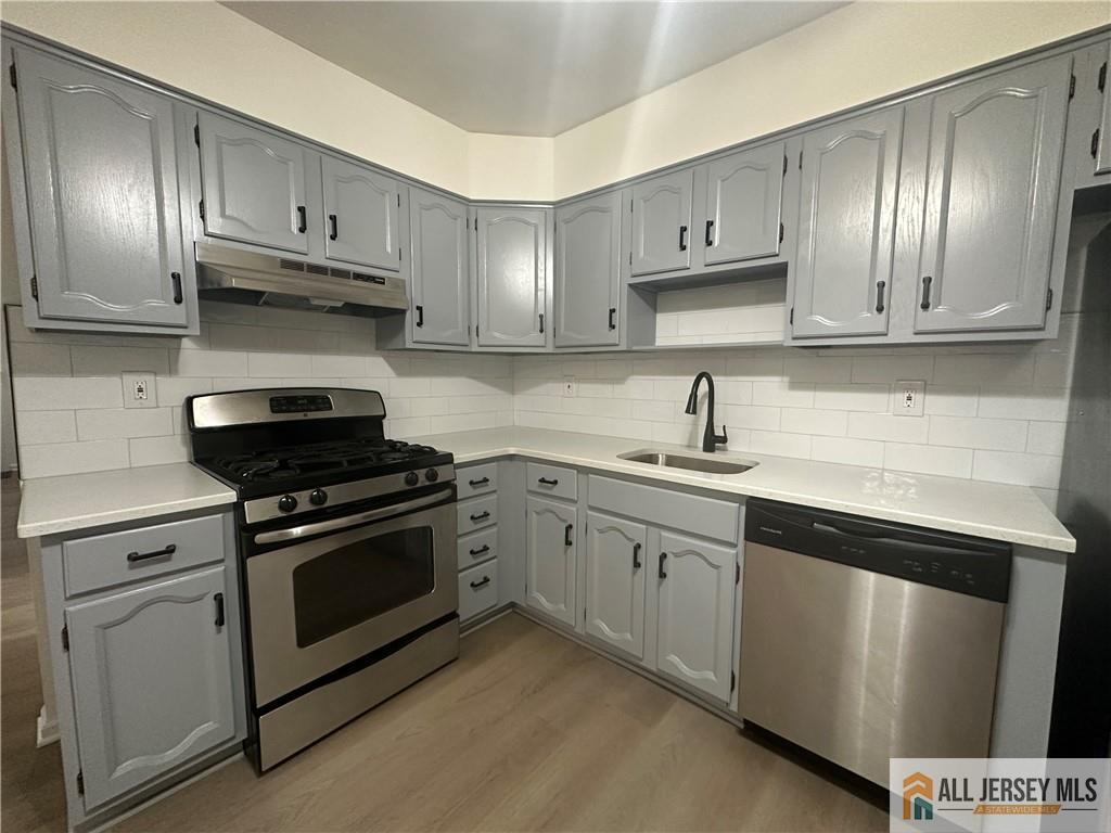 204 Maplecrest Road, Unit 204 Edison, NJ 08820 - Photo 7 of 15 a kitchen with cabinets stainless steel appliances and a sink