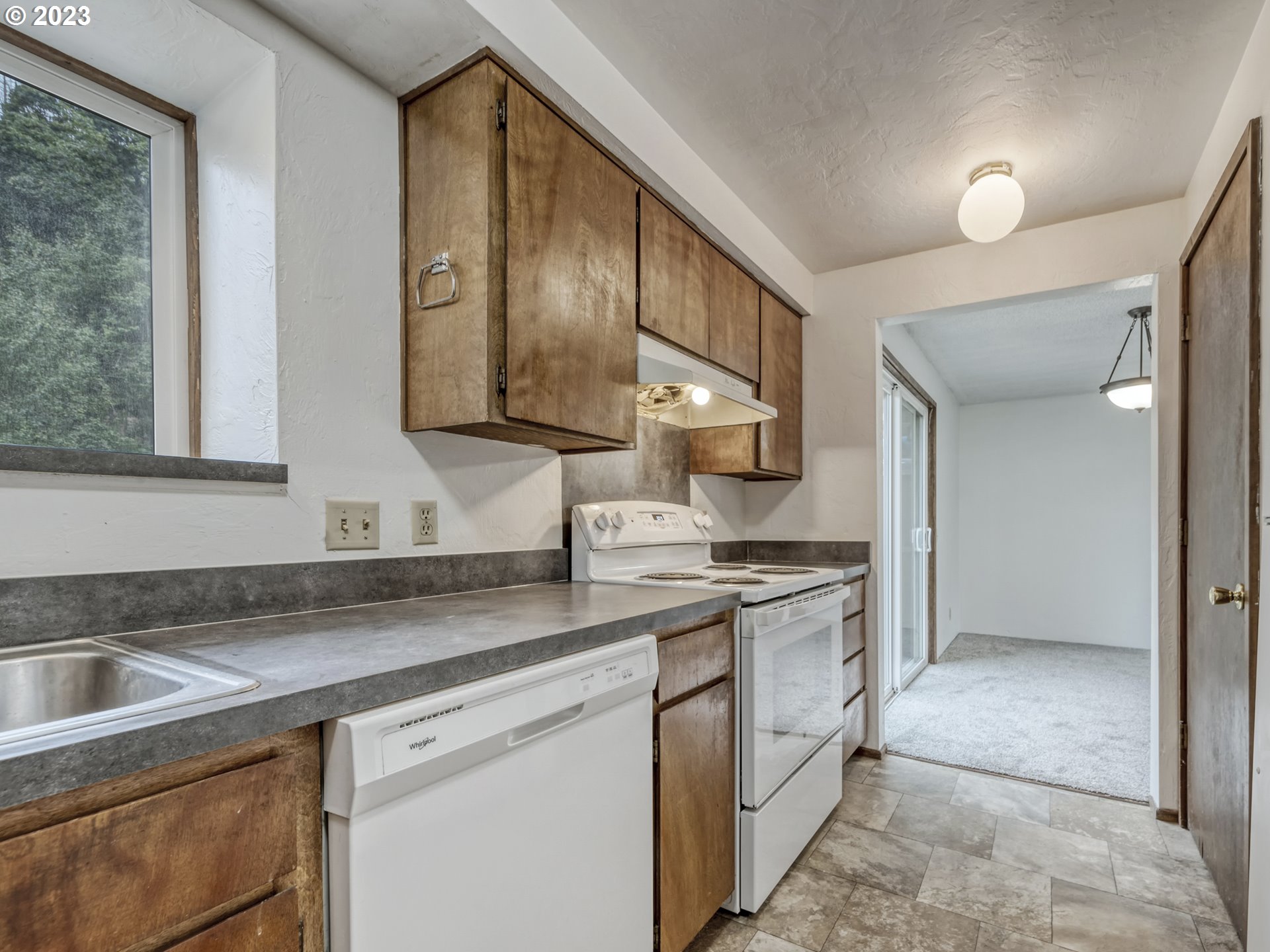 1357 East 43rd Avenue Eugene, OR 97405 - Photo 6 of 28 a kitchen with a sink stove and cabinets