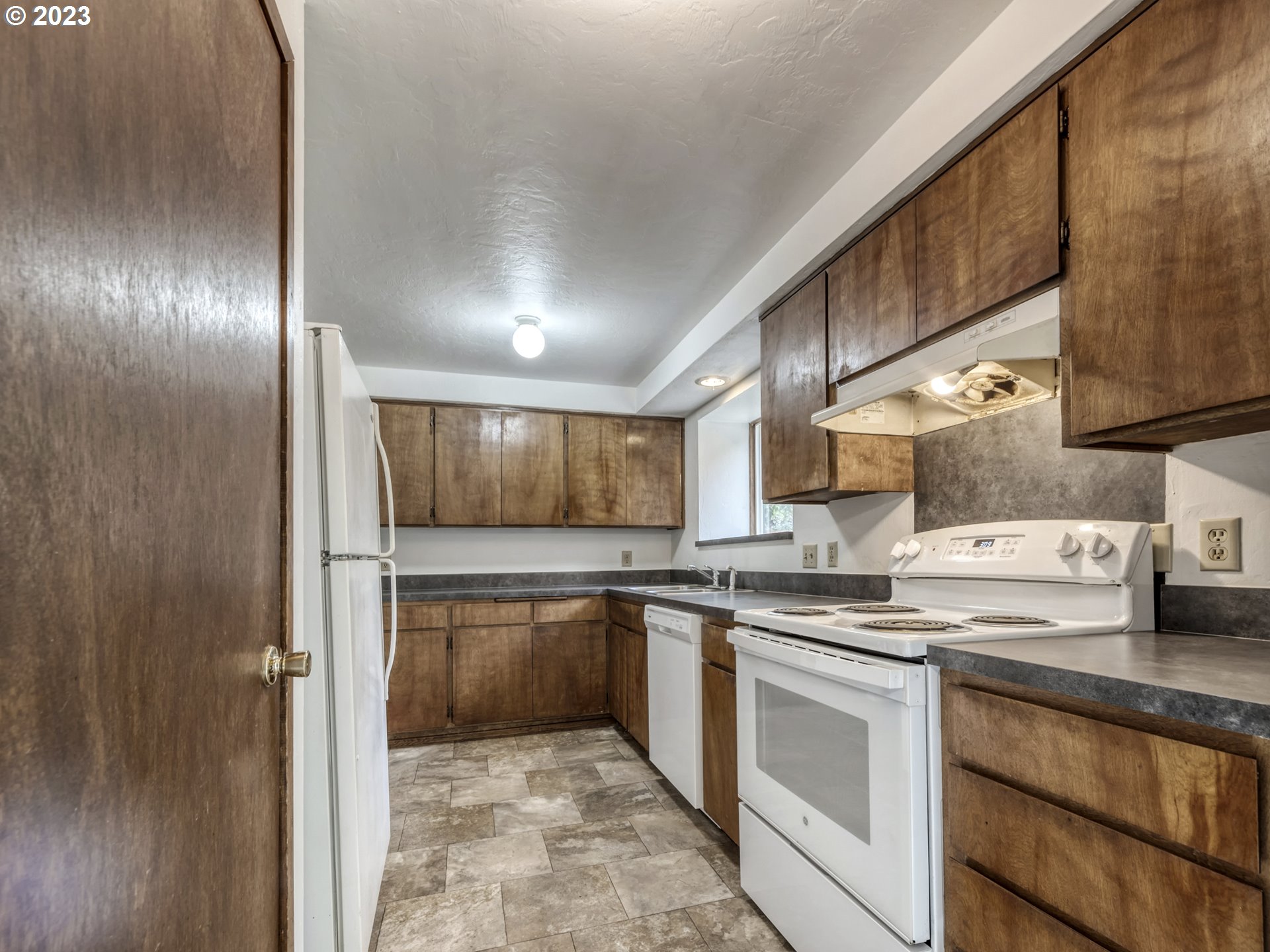 1357 East 43rd Avenue Eugene, OR 97405 - Photo 7 of 28 a kitchen with stainless steel appliances granite countertop a sink and a stove top oven