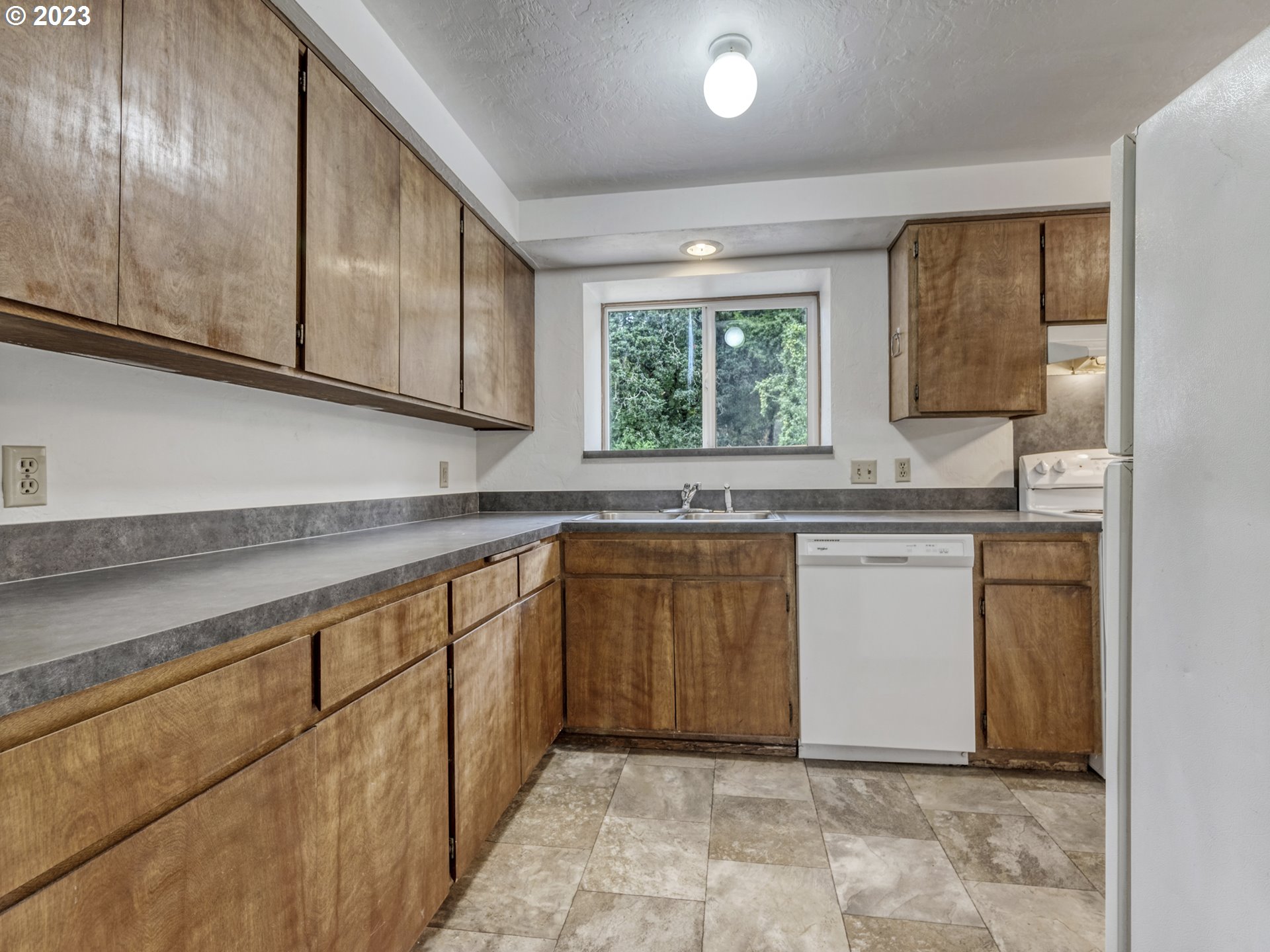 1357 East 43rd Avenue Eugene, OR 97405 - Photo 8 of 28 a kitchen with granite countertop a sink and a stove