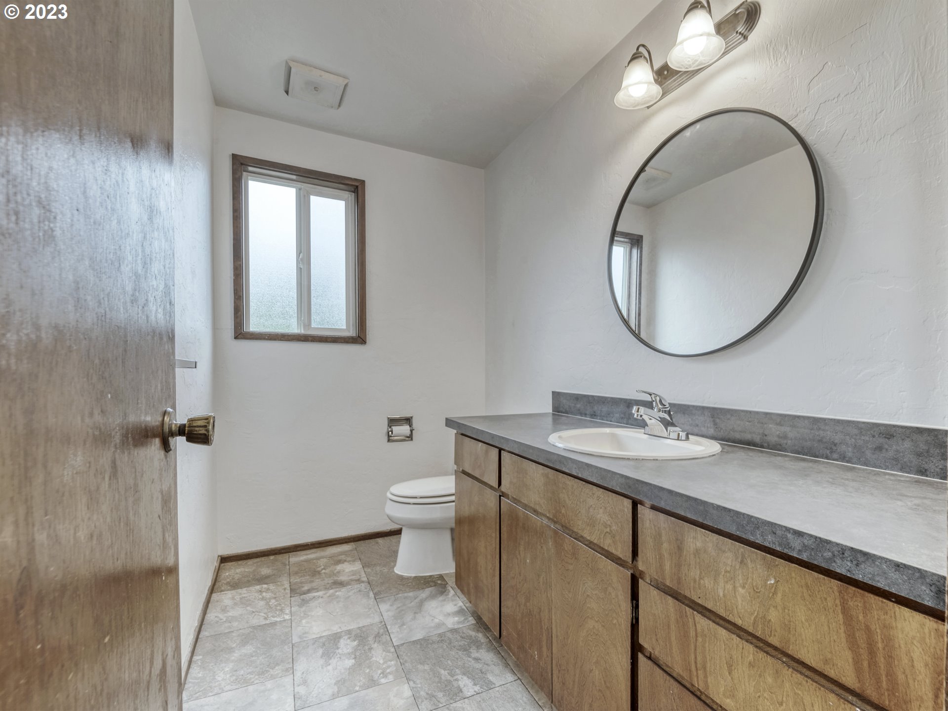 1357 East 43rd Avenue Eugene, OR 97405 - Photo 9 of 28 a bathroom with a sink and a mirror