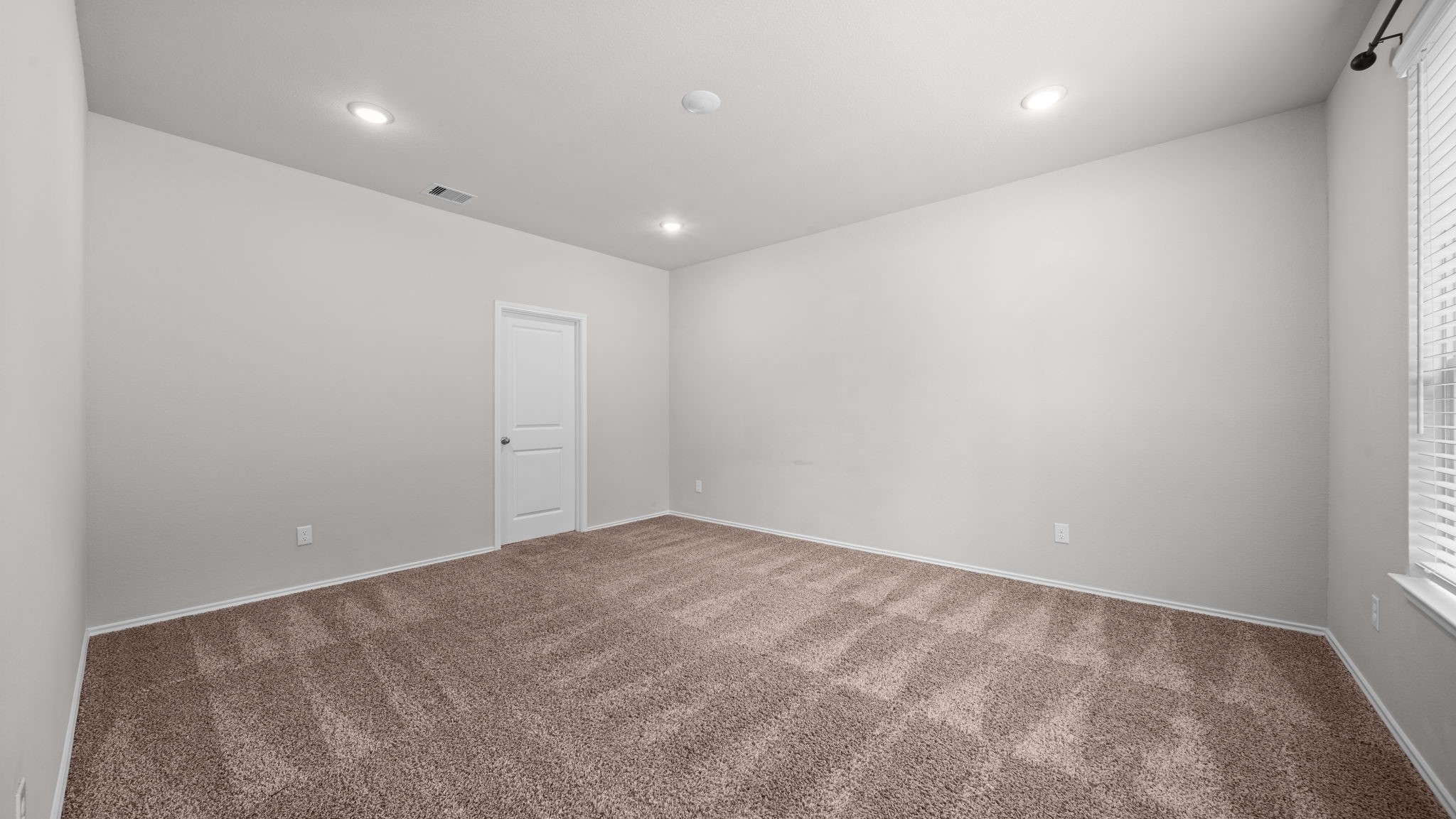 18140 Mail Rte Road Montgomery, TX 77316 - Photo 12 of 26 Spacious primary suite featuring plush carpet, recessed lighting, and plenty of room for a king-size bedroom set.