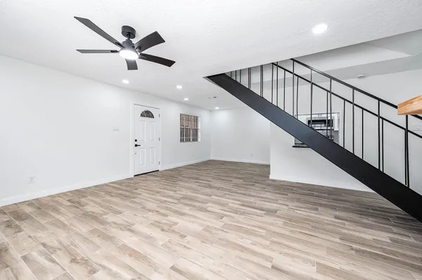a view of an empty room with wooden floor