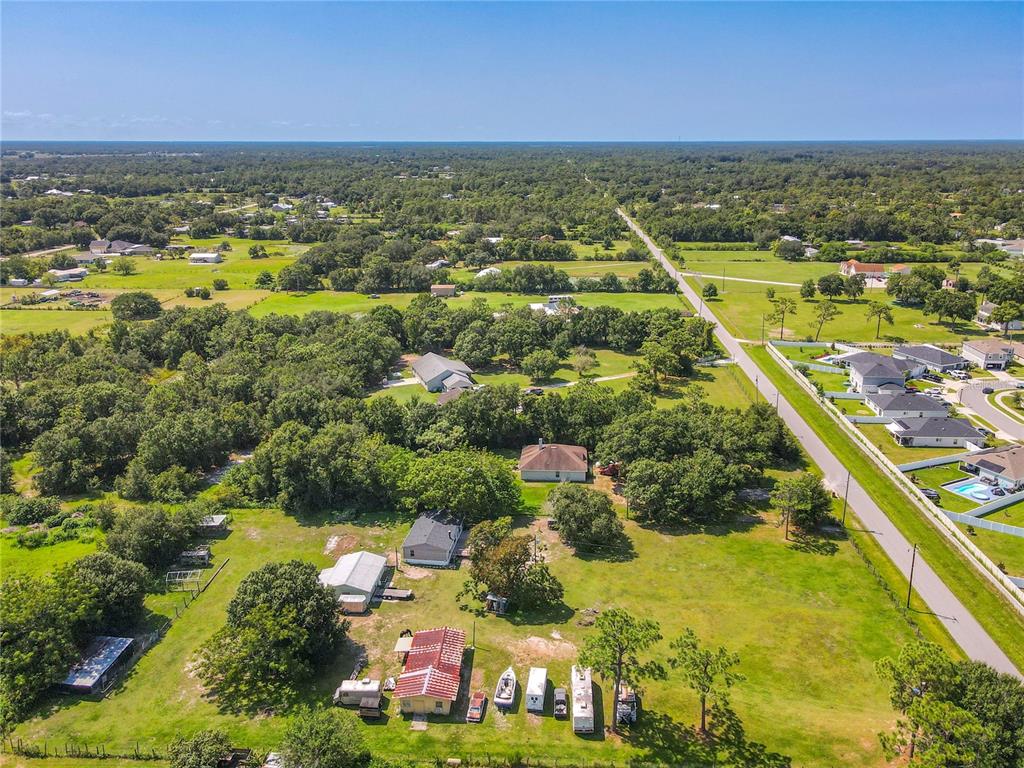 a view of a city with lots of residential buildings ocean and mountain view in back