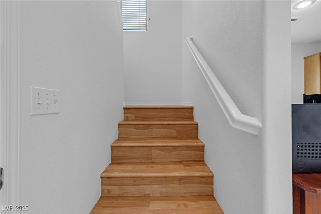 9065 Starling Wing Place Las Vegas, NV 89143 - Photo 11 of 53 Stairway with wood finished floors