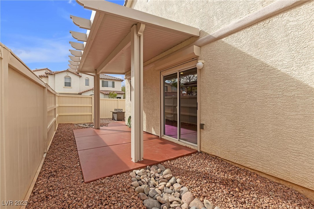 9065 Starling Wing Place Las Vegas, NV 89143 - Photo 30 of 53 Fenced backyard with a patio area